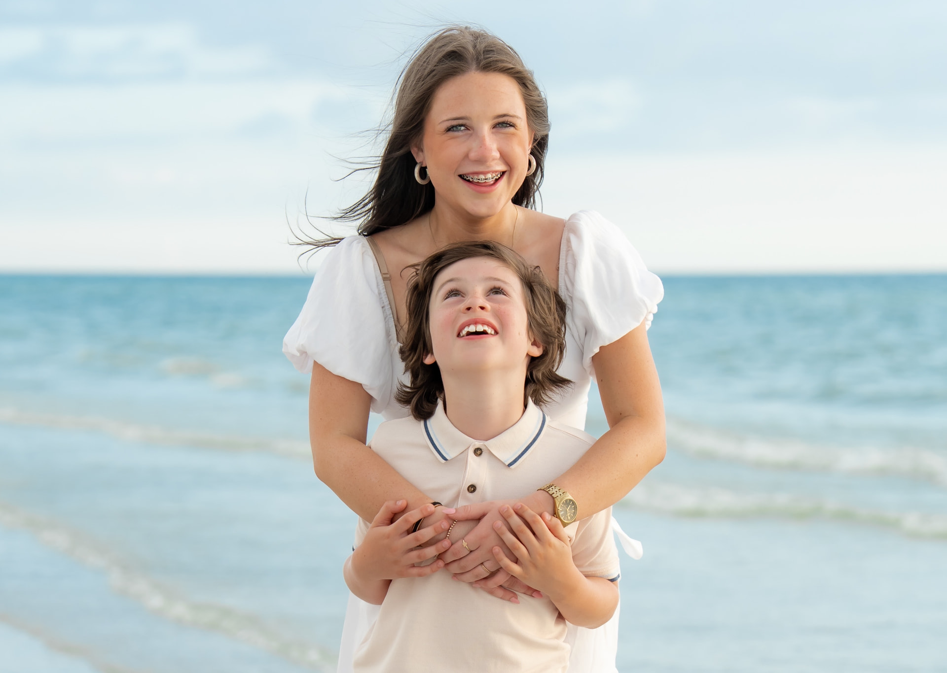 Family with two young children wading in the Gulf during a beach photography session