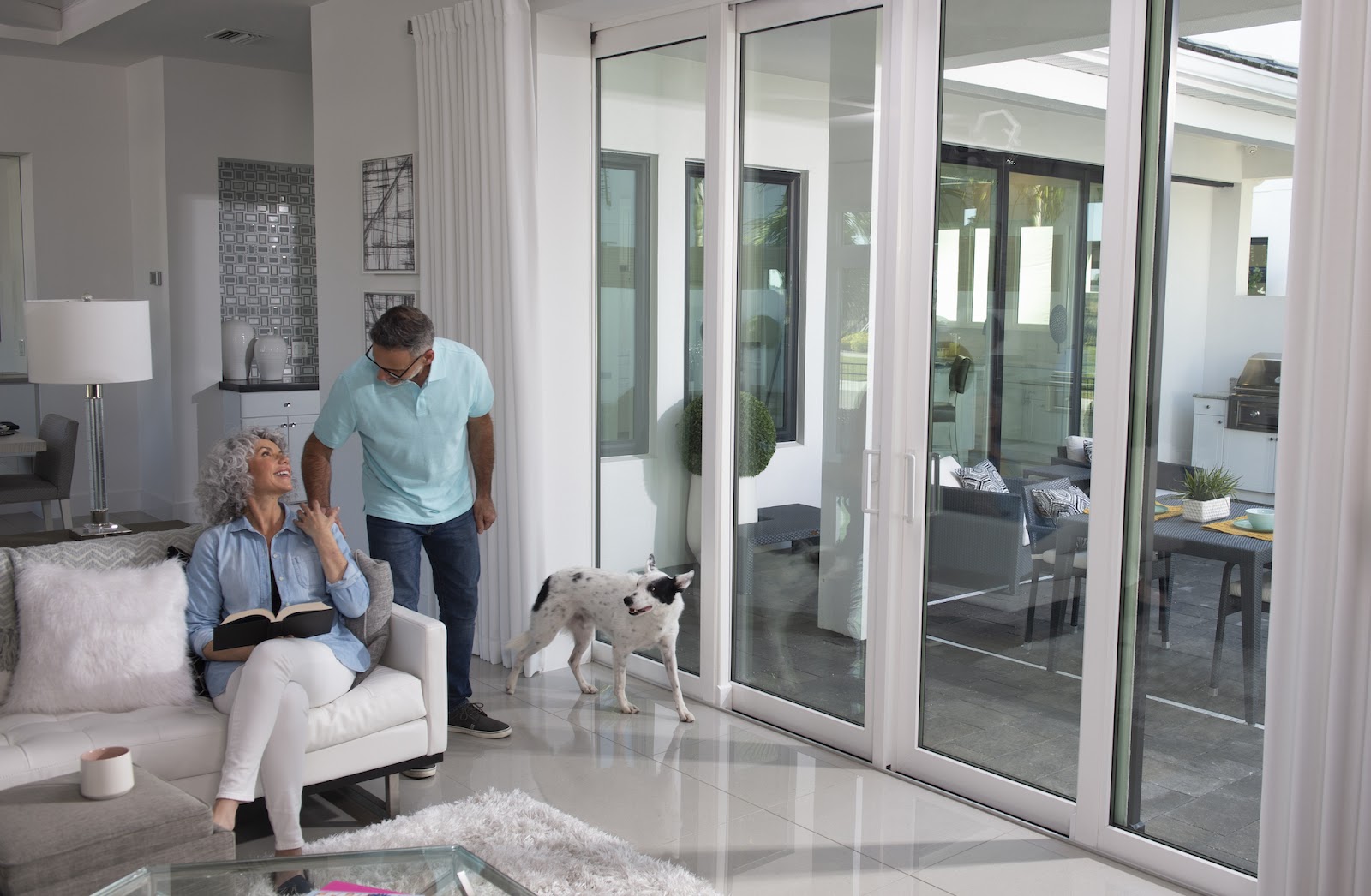 Living room with floor-to-ceiling impact sliders by Naples Windows, a Mighty Fine Company™